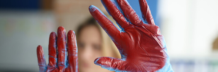 Bloodied hand in doctor medical gloves in clinic