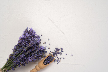 home spa with lavender herbs for bath on white background. lavender flowers in wooden spoon, branches, Top view, close-up, flat lay, copy space