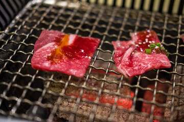 Grilling wagyu beef on a charcoal grill. Close up