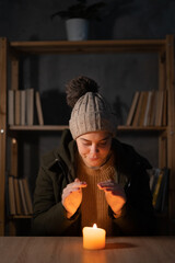 Young student suffers in no heating and no electricity during an energy crisis in Europe causing...
