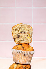 Close-up of chocolate and banana muffins in stack, colorful background, hard light