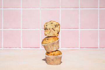 Chocolate and banana muffins in stack, colorful background, hard light - 542346492