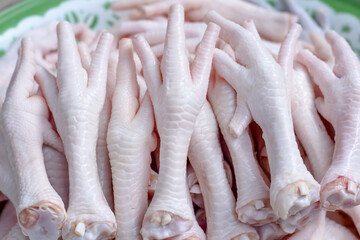 Many chicken feet pile close up thai food background © Amphawan