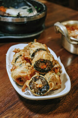 A plate of Korean cuisine that resembles sushi known as Gim Mari with blurred background