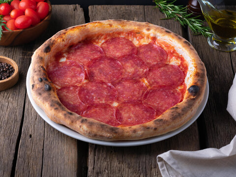 Traditional pizza paperoni with ingredients. Rustic style.