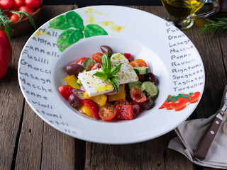 Greek salad on rustic background . Healthy food concept