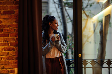 African American woman having coffee at home.