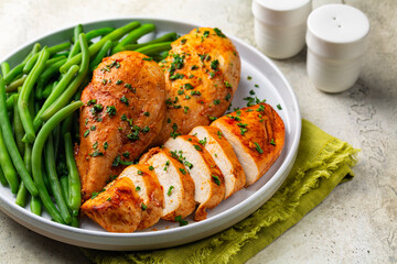Oven baked boneless chicken breast made with paprika and parsley,  green beans. Healthy eating concept. - obrazy, fototapety, plakaty