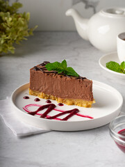chocolate cheesecake with chocolate glaze on white marble background. Vertical
