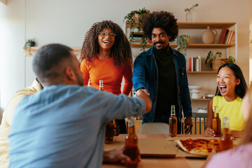 Cheerful friends gathering at home.