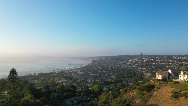 Aerial Overhead Shot of La Jolla, California Flying Over Homes Towards La Jolla Pier in the Pacific Ocean on a Beautiful Sunny Day