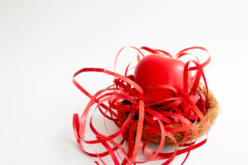 Close up red Heart bedded with red ribbon on white background