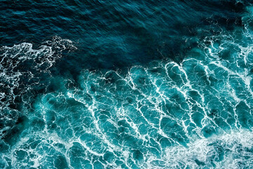 Aerial view to seething waves with foam. Waves of the sea meet each other during high tide and low tide - 542350260