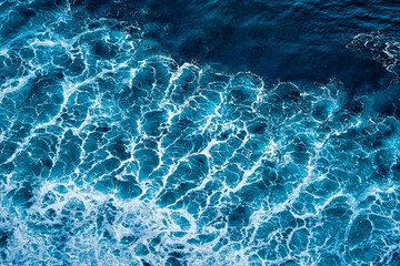 Aerial view to seething waves with foam. Waves of the sea meet each other during high tide and low...