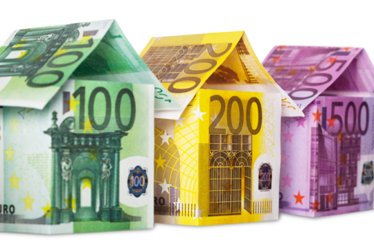 Three houses made of euro notes isolated on white background