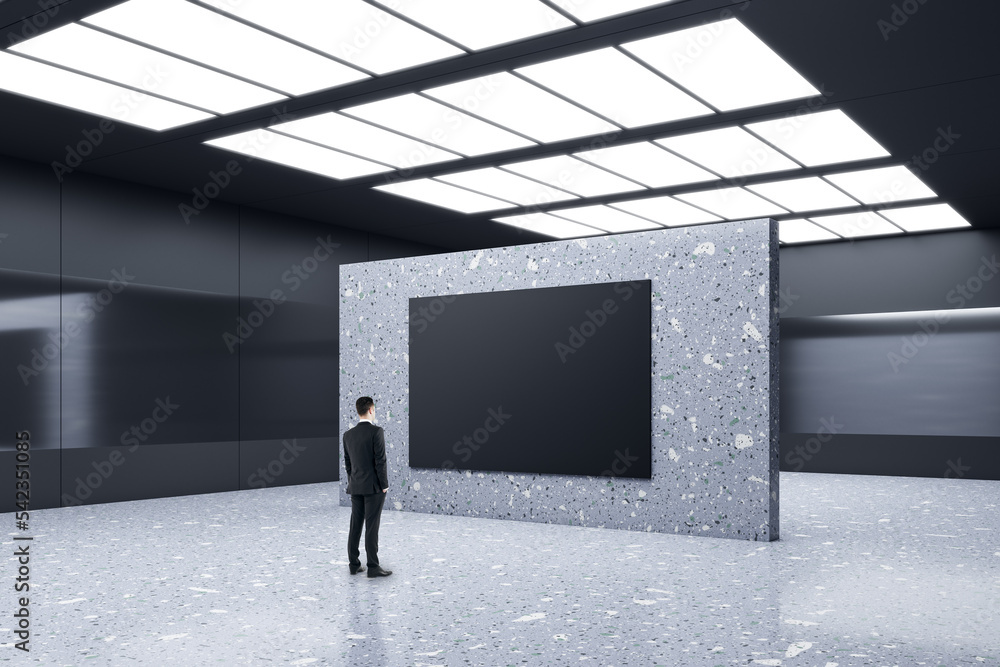 Poster advertising concept with businessman perspective view in front of blank black poster with place for 