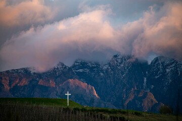 Scenic view of clouds over the mountains and a cross in Villiersdorp, South Africa.