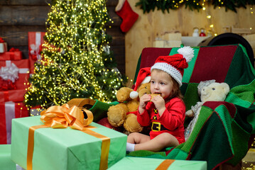 Christmas portrait of cute little baby in santa hat. New Year toddler.