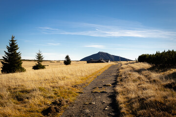 sniezka, the highest peak of the Sudetes. view from the golden autumn clearing. hotel lucni bouda and trail. Poland/Czech Republic