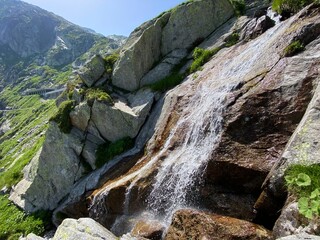 Mountain waterfalls and cascades of alpine streams in the area of the mountain Gotthard Pass (Gotthardpass) in the Swiss Alps, Airolo - Canton of Ticino (Tessin), Switzerland (Schweiz)