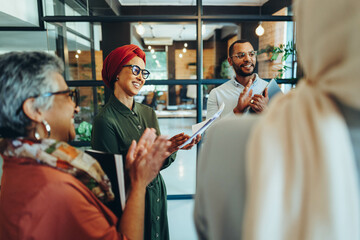 Successful business team applauding during a meeting