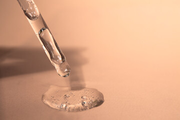 Cosmetic pipette with hyaluronic acid on a plain background. Beauty concept.