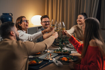 close up friends making toast on home dinner party