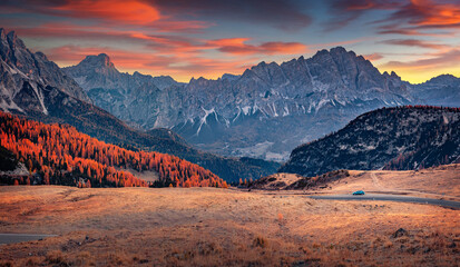 Traveling by car to Giau pass, Italy, Europe. Fantastic sunrise in Dolomite Alps. Traveling concept background..