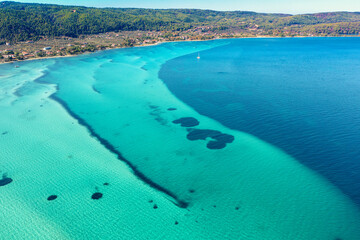 Seascape on a sunny day. View from above. Beautiful bay in Vourvourou, Halkidiki, Greece