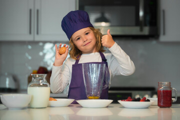 Chef child cooking. Child making tasty delicious. little boy in chef hat and an apron cooking in the kitchen. Kid boy in chef hat and an apron cooking in the kitchen.