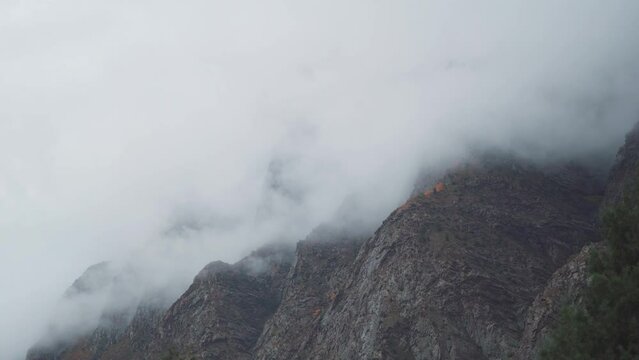 4K shot of clouds above the mountain peaks during the storm at Jispa in Lahaul Spiti district at Himachal Pradesh in India. Clouds covers the peaks of the mountains. Natural background. 