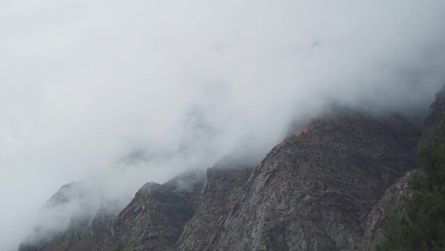4K shot of clouds above the mountain peaks during the storm at Jispa in Lahaul Spiti district at Himachal Pradesh in India. Clouds covers the peaks of the mountains. Natural background. 