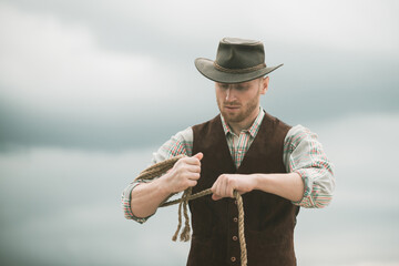 Cowboy wearing hat. Western life. Handsome bearded west farmer. Portrait of man cowboy or farmer....