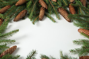 New Year's Eve background with fir branch and cones. Christmas and New Year holidays composition of pine tree branches.