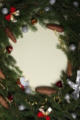 Fototapeta na wymiar New Year's Eve background with fir branch and cones. Christmas and New Year holidays composition of pine tree branches.