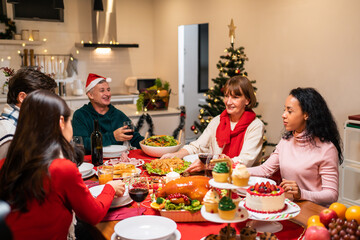 Multi-ethnic big family celebrating Christmas party together in house.	