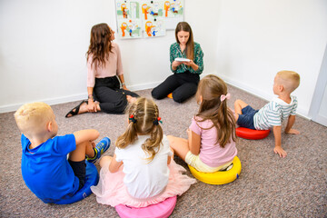 Child occupational therapy background. Elementary age children in group therapy. Teacher and pupils...