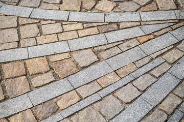 Road paving slabs pattern. Way paved with stones.
