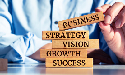 Wooden blocks with words 'business, strategy, vision, growth, success. business growth