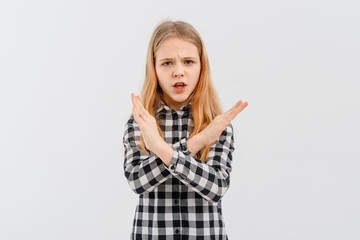 Dont like it. Upset teen girl shows stop, cross hands gesture, rejecting something, refusing and prohibiting, saying no, standing over white background.