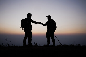 Obraz na płótnie Canvas Silhouette of Teamwork helping hand trust help