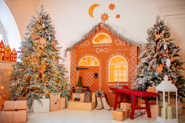 Happy new year interior christmas Gingerbread house. Decorated glowing tree with gifts xmas