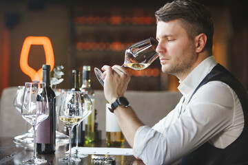 Wine expert smells alcoholic drink to give it rating.