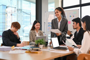 Confident African female manager giving presentation, convincing business partners on negotiations at marketing workshop