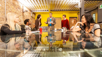 The Media Agency: Working Together. Meeting in a contemporary board room with a young team of Creative Professionals. From a series of related images.