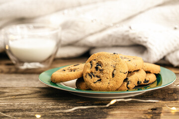 Cookies with chocolate chips close-up and glass of milk.