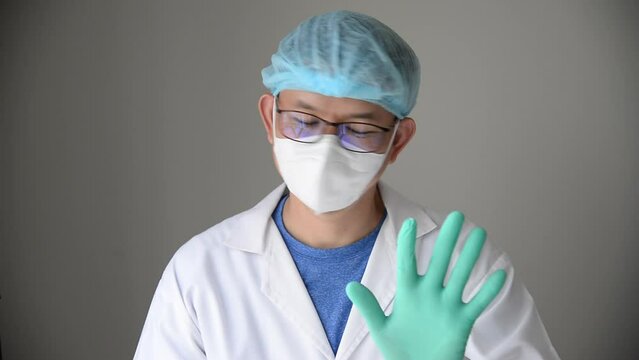 portrait of asian surgeon wave his hand to deny or tell someboey donot do something