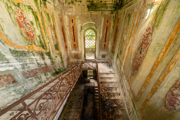 abandoned stairwell in an old abandoned overgrown villa