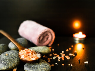 Himalaya Salt on Spoon and Zen Stone and Towel with Candle on Black Wooden Table Background,Aromatherapy Spa Set,Treatment Herb Nature for Beauty Salon,Medicine Hygiene Luxury in Holiday Relax.