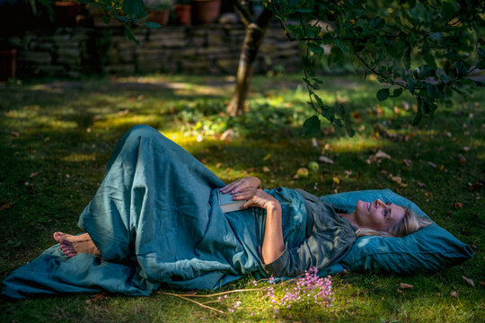Smiling woman lying down in garden